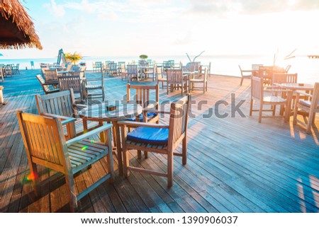 Summer empty open air cafe at exotic island at sunset