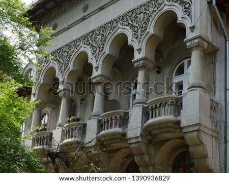 Ancient chic fundamental balcony with beautiful arched columns and patterns on the facade in an old residential building of the 19th century in the old district of Chernivtsi.
