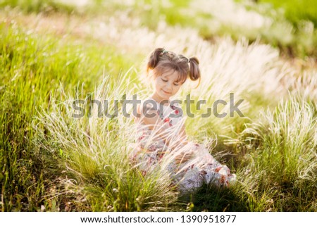 portrait of a little beautiful girl child on the background of a blooming park in spring, summer flower mood.
