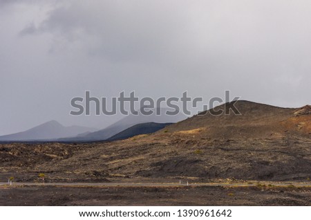 Landscape of a storm over the volcanoes of Timanfaya national park, in Lanzarote