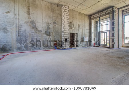 Commercial space for real estate as restaurant,  hairdressing salon on ground floor of apartment house. Large hall with panoramic window is unfinished construction. Thermal radiator battery on wall.