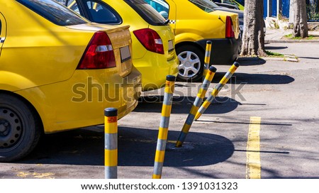 twisted yellow street pins. car drivers and taxis hit safety pins. broken frames distorted by strikes.