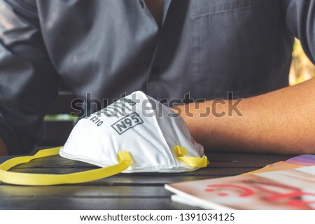 closeup N95 air filter mask. personal protective equipment in office with soft-focus and over light in the background Royalty-Free Stock Photo #1391034125