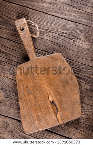 Russia, rustic old vintage wooden cutting board for the kitchen, with a groove structure, stripes, lies, stands on the table are cracks, black, brown, round square oval right angles sharp, rope