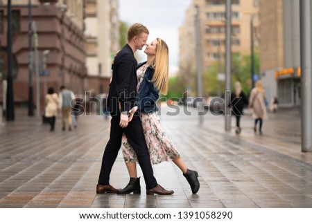 a loving couple of young people dancing in the city