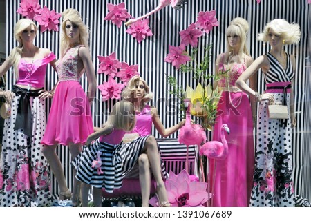 showcase with fashionable clothes of pink and black and white colors