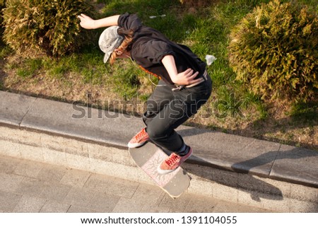 The guys on the skateboard ride on the street.