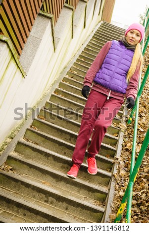 Outdoor sport exercises, sporty outfit ideas. Woman wearing warm sportswear training exercising outside during autumn.