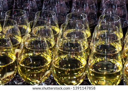 Rows of glasses full of wine at a romantic banquet at a nightclub close-up shot.
