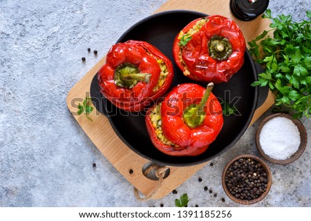 Red pepper stuffed with meat, bulgur and vegetables in a cast-iron pan. Baked stuffed peppers. Royalty-Free Stock Photo #1391185256