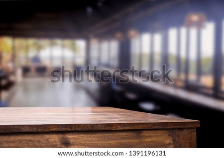 Wooden table on abstract blurred interior restaurant background and free space for decoration display or montage products.