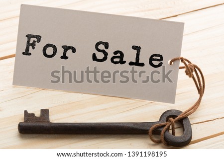 Business concept - Old key vintage on wood with tag For Sale.