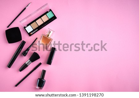 Different makeup products composition on pink background, flat lay and top view photo