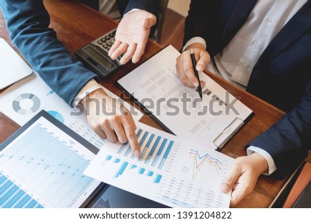 Business Corporate team brainstorming, Planning Strategy having a discussion Analysis investment researching with chart at office his desk documents and saving concept. Royalty-Free Stock Photo #1391204822