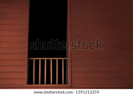 Wooden balcony with dark room in window. Thai style house. Haunted house background concept.