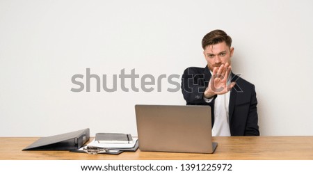 Businessman in a office making stop gesture