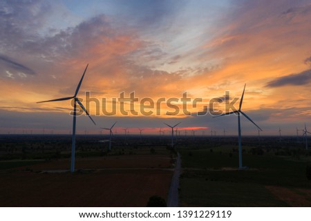Aerial view of wind turbines in beautiful sunset. Production of clean energy without pollution for the environment. Cleaner Power generation