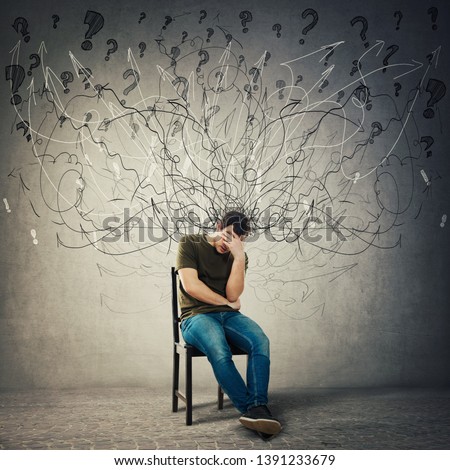 Pessimistic, disappointed man sitting on a chair in a dark room covering face with hand. Desperate guy seated alone suffer anxiety, distress depression feeling. Mess go out of head, losing memory. Royalty-Free Stock Photo #1391233679