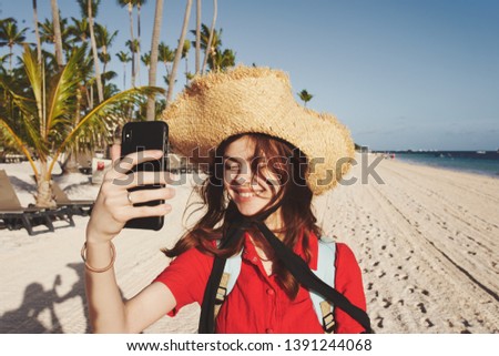     Trip woman in hat smiling selfie on phone island                           