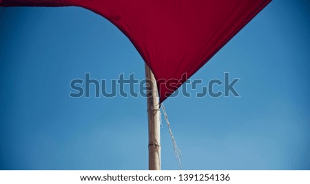 A red clothes tied with a bamboo isolated unique photo