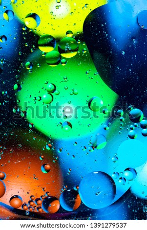 Mixing water and oil on a beautiful color abstract background gradient balls circles and ovals 