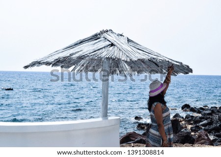 Girl wearing hat enjoying on a sea beach and giving poses for photographs 