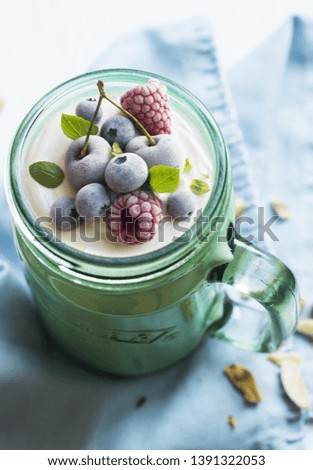 delicious berry dessert in a jar on the table
