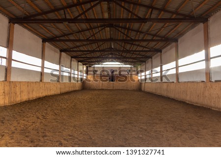A large arena with sand for horses Royalty-Free Stock Photo #1391327741