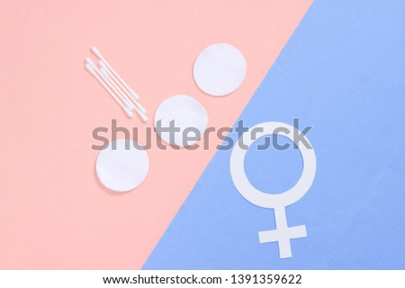 Products for feminine hygiene, self-care and health, female gender symbol on pastel background. Ear sticks, pads. Top view