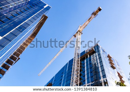 Crane and skyscrapers under construction in San Jose, South San Francisco bay area 