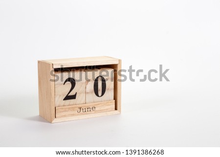 Wooden calendar June 20 on a white background close up