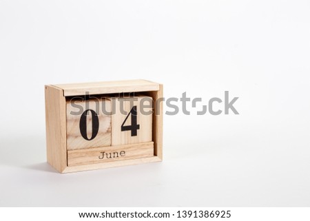 Wooden calendar June 04 on a white background close up