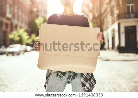 Human rights. Cropped image of young woman holding a blank signboard while standing on the road.
