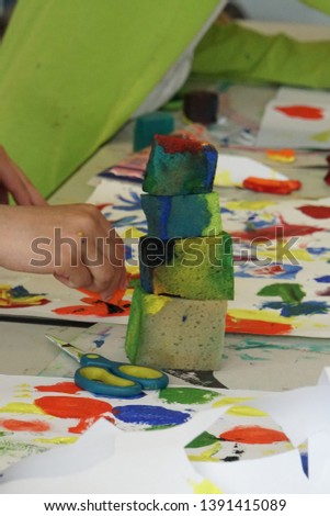 Sponge stack on the table. Creative Art Workshop. School kids working with Colors. Paper Sheet on The White Wood Table.