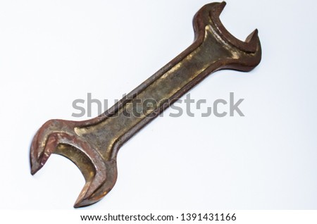 Rusty textured wrench. Isolated on white background.