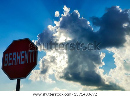 Selective focus. Silhouette. Grain tone. Signboard says stop with cloud background 