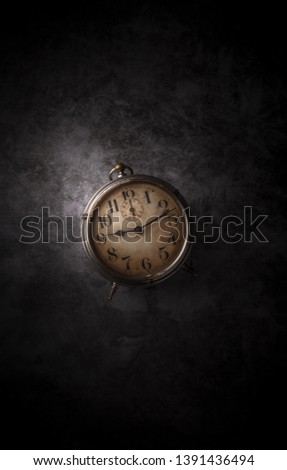 Rustic old metal clock arrangement on dark old gray marble table background overhead with copy space studio shot
