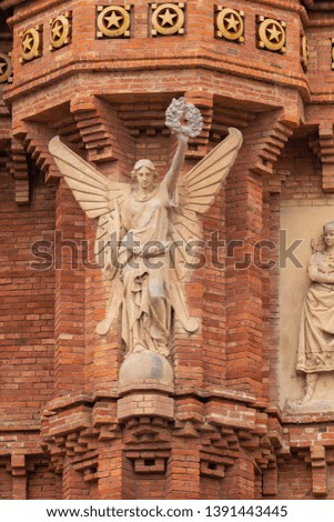 Elements of architecture of buildings made of red bricks, sculptures and religious characters. On the streets in Catalonia in public places.