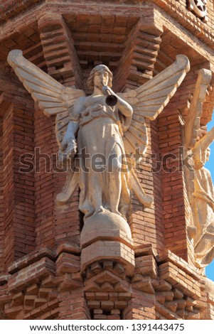 Elements of architecture of buildings made of red bricks, sculptures and religious characters. On the streets in Catalonia in public places.