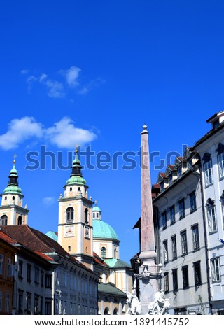 A photo of Stari Trg square and church in the very city centre of the capital city of Slovenia Ljubljana with blue sky with clouds in background.