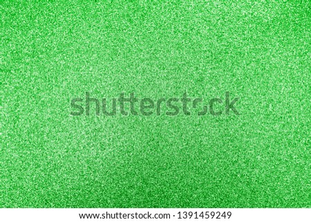 Closeup of green glitter texture. Photo of sparkle dust background.