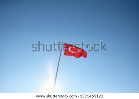 Turkey flag waving in the wind against white cloudy blue sky together. 