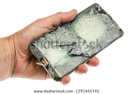 Mobile phone with a badly shattered screen after a serious fall.