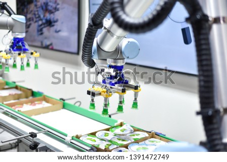 Mechanical robot with artificial intelligence sorts products on the conveyor. Royalty-Free Stock Photo #1391472749