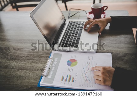 Business analysis concept. Businesswoman analyzing business documents, finacial report, working on laptop computer, mobile smart phone on office desk, close up. Royalty-Free Stock Photo #1391479160