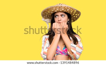 Teenager girl on summer vacation nervous and scared putting hands to mouth over isolated yellow background