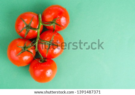Creative layout of tomatoes on bright background. Studio Photo