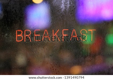 Retro Restaurant Sign in Wet Window, Breakfast