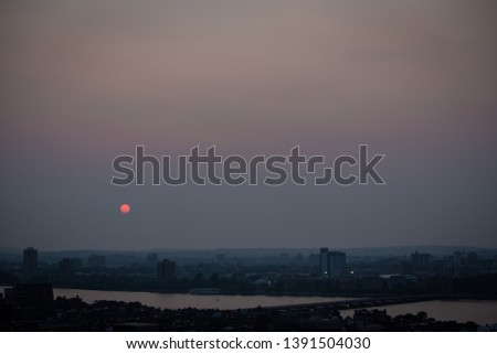 Hazy sunset over Cambridge Massachusetts with the Charles River in view.