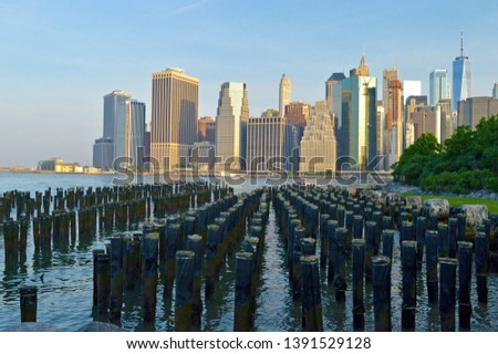 contrast of modern New York city and old dock